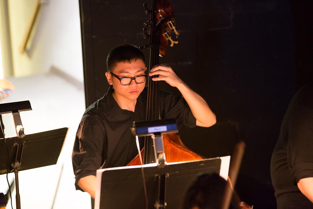 Image of Tommy Wu playing bass.